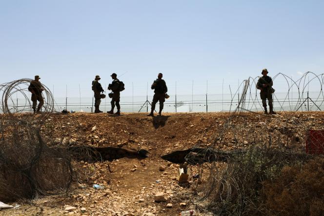 Israeli soldiers walk along the barbed wire that separates Israel from the West Bank, as part of the search for six escaped Palestinians, September 9, 2021.
